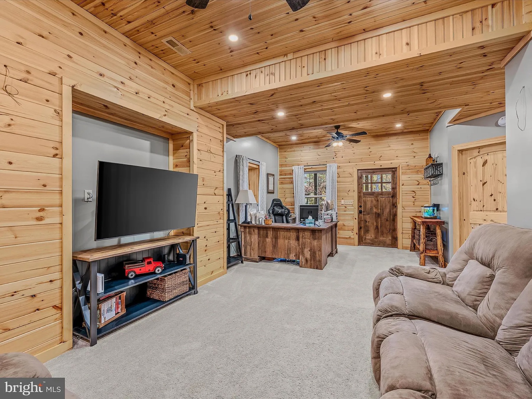 Plain wood-paneled cabin office before design